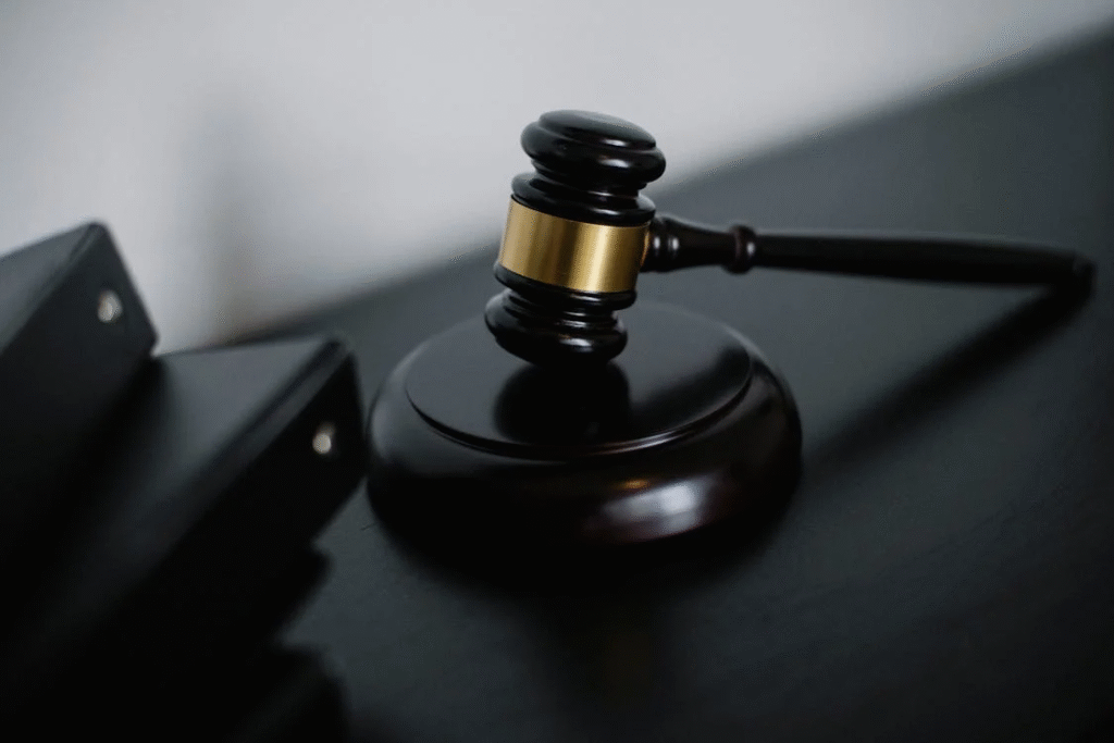 close-up shot of a black gavel next to folders