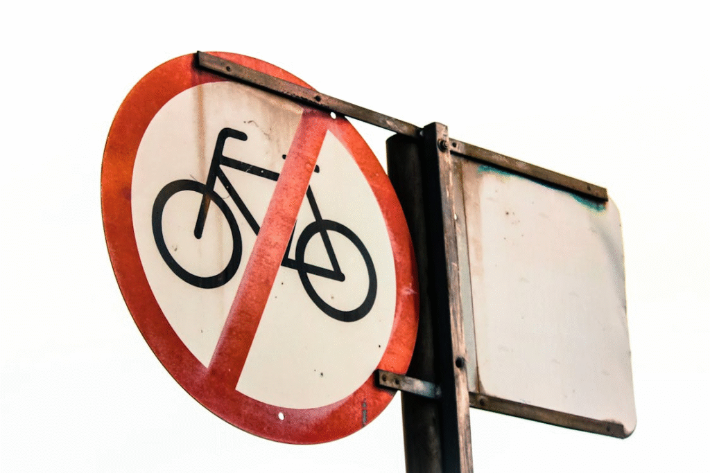 a circular signage restricting cycles on the road