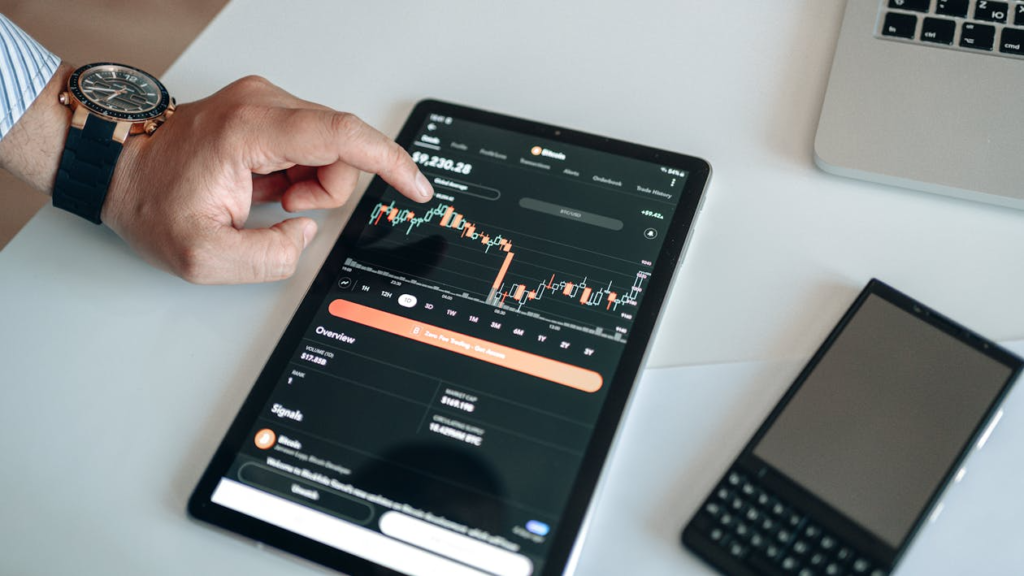 Tablet screen displaying cryptocurrency market data and charts