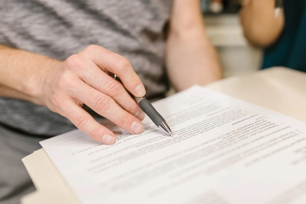 An image of a man reviewing legal documents