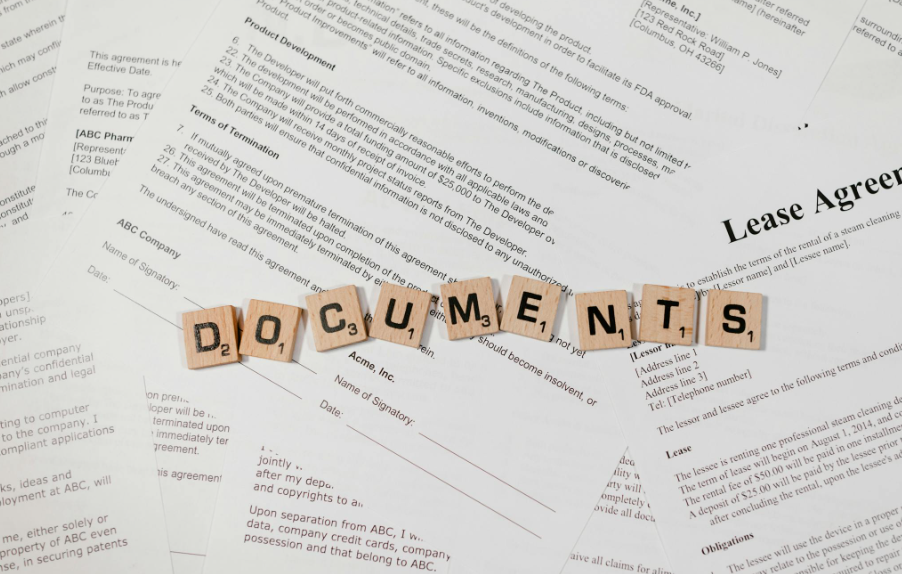 This image shows the word ‘documents’ spelled with Scrabble tiles placed on top of documents.