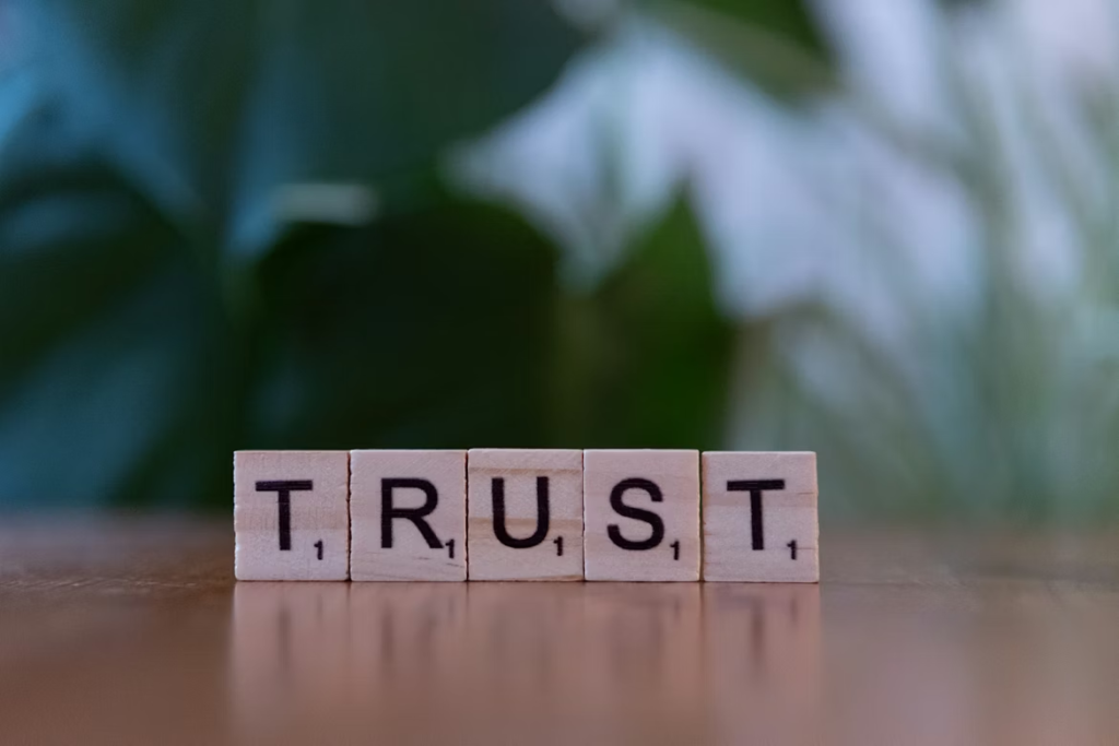 Scrabble tiles spelling “trust.”