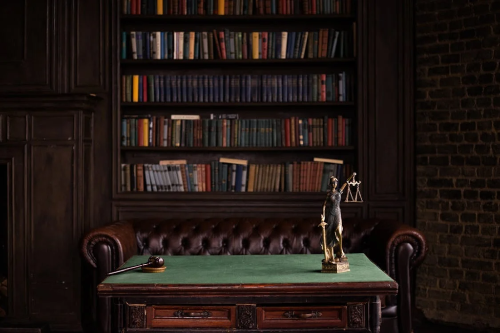 An image of a gavel and a lady justice statue on a table