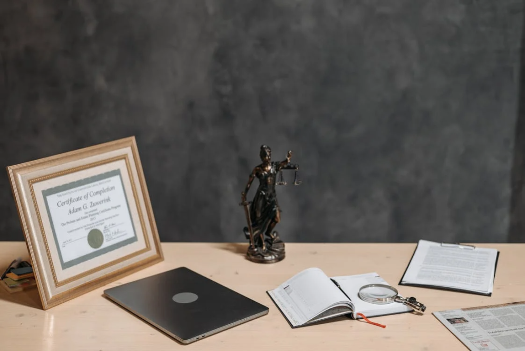 An image of a lady justice statue and documents on a table