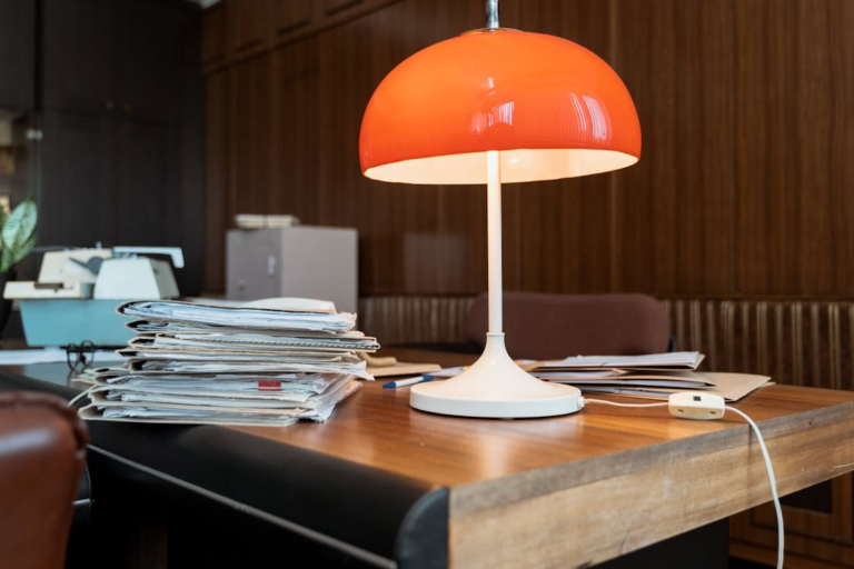 Stack of legal documents and manila folders arranged on a wooden office desk