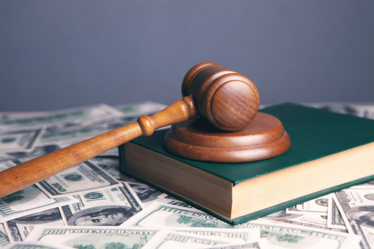 A brown wooden gavel on a book