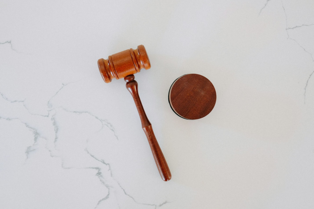 A wooden gavel resting on a marble block