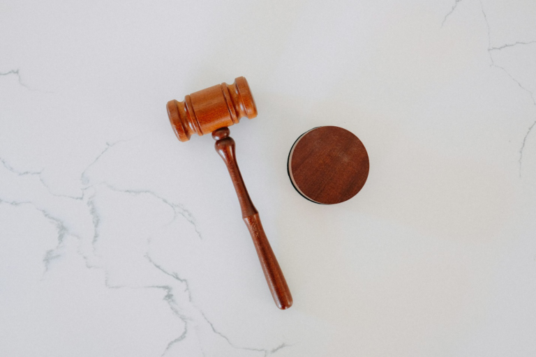 A wooden gavel resting on a marble block