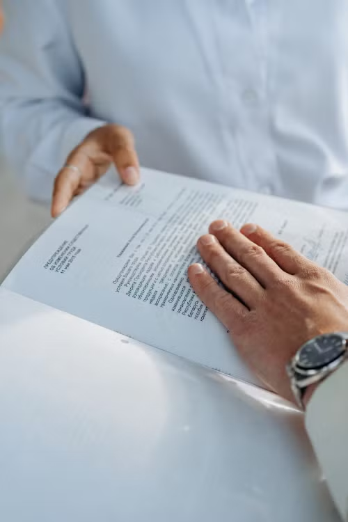 An image of a person placing their hand on a document