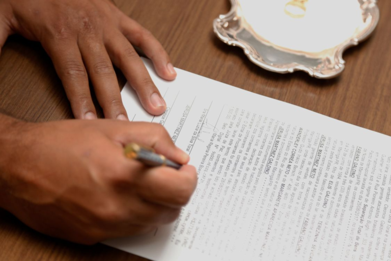 An image of a person signing a document