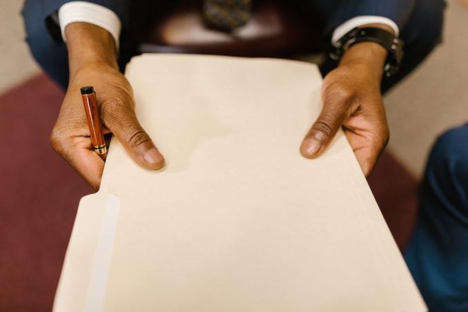An image of a man holding a file