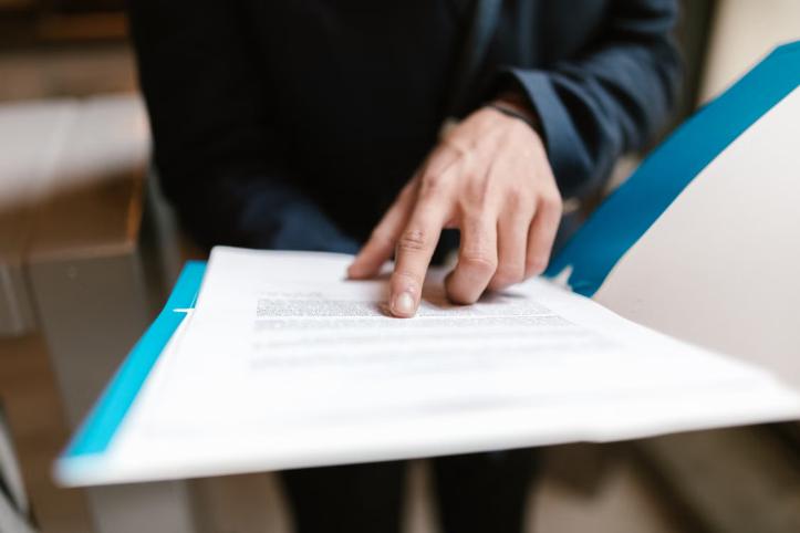An image of a man reading a document