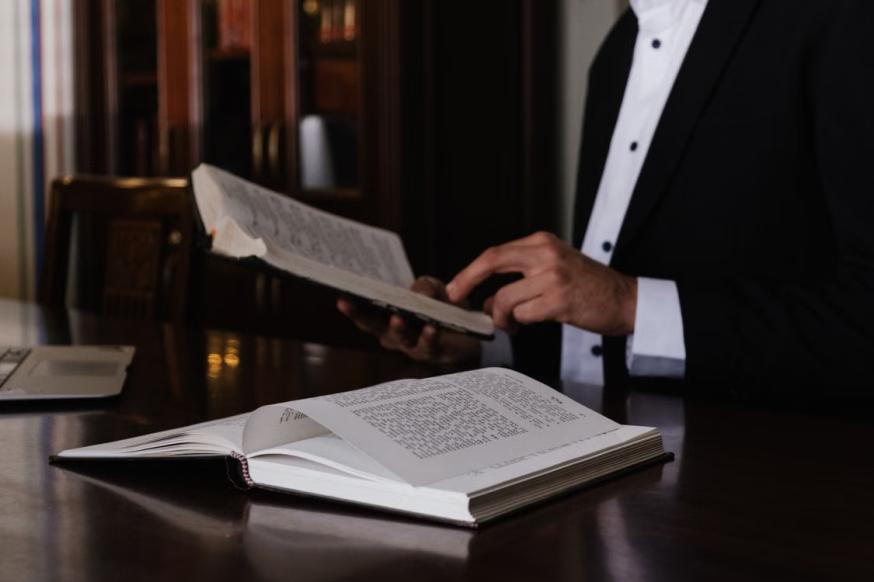 An image of a man reading a book