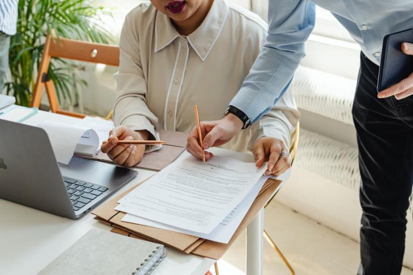 An image of a man signing a document