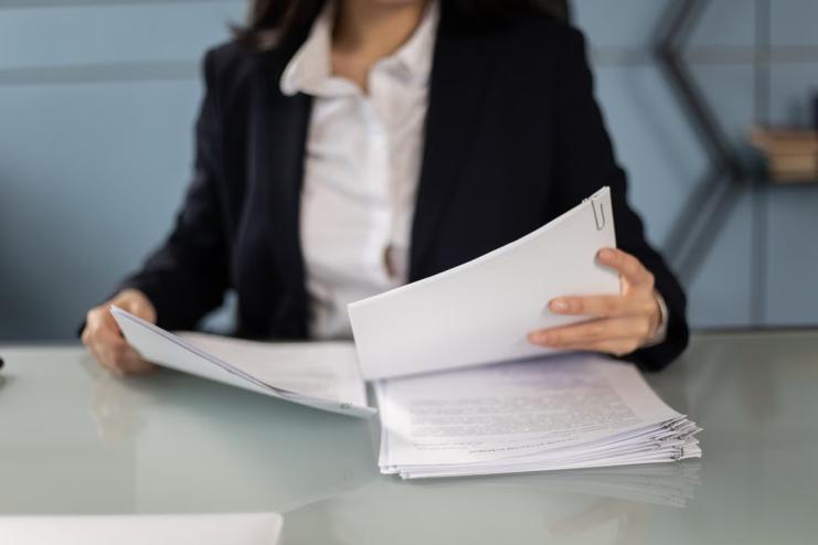 An image of a woman going through some documents