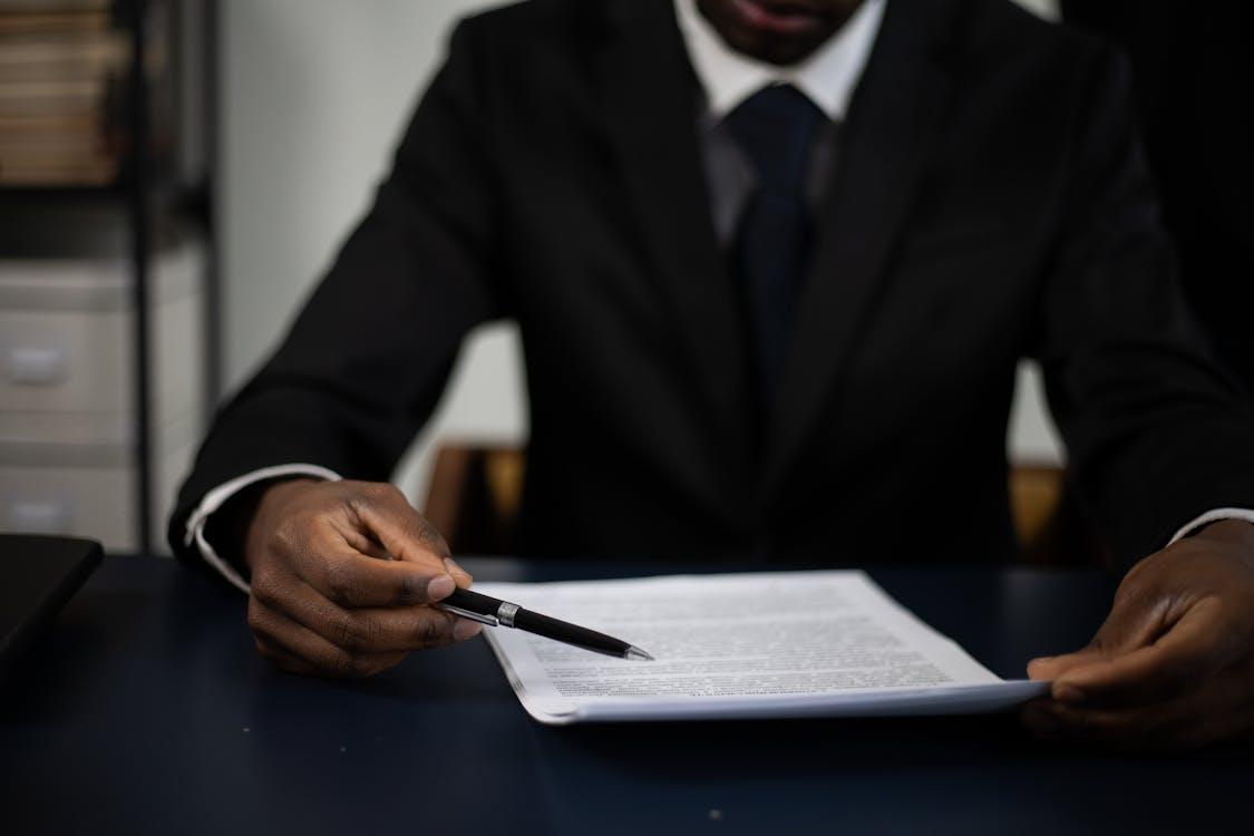An image of a man in a suit reading a document