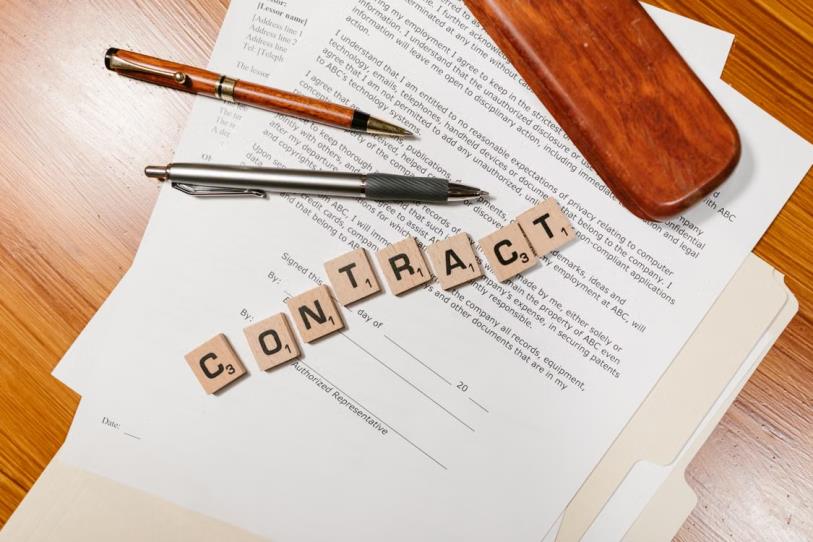 An image of papers and pens on a desk