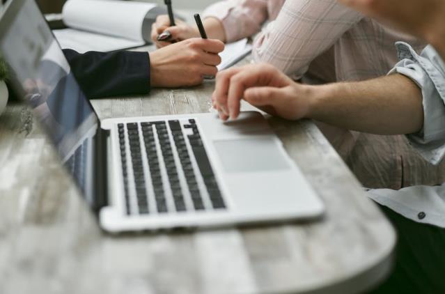 An image of a person working on a laptop