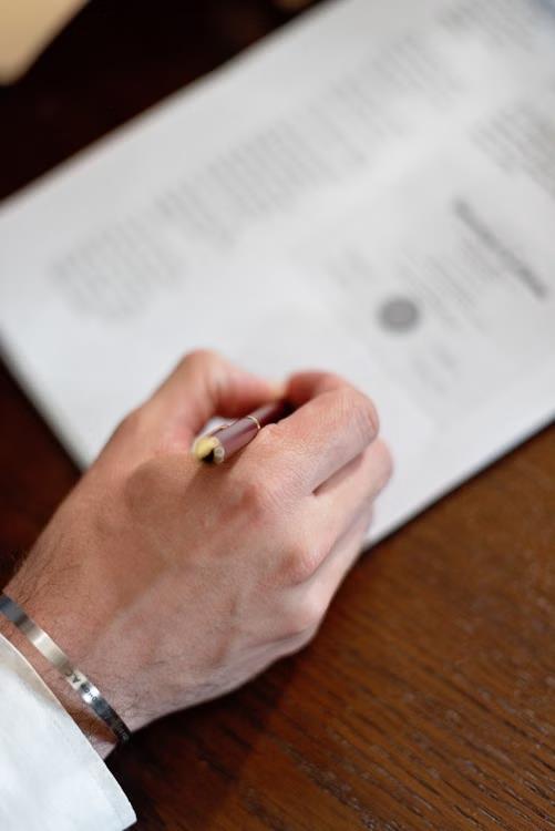 An image of a person signing a document