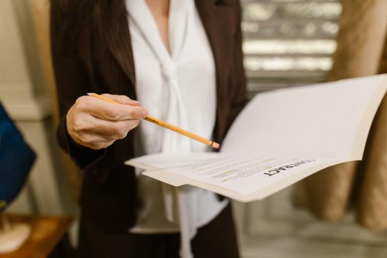 An image of a person holding a contract