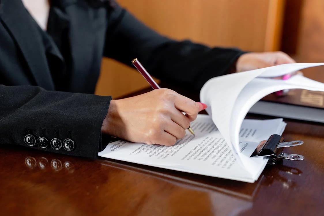 An image of a person signing papers