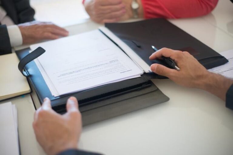 An image of a person showing papers in a file