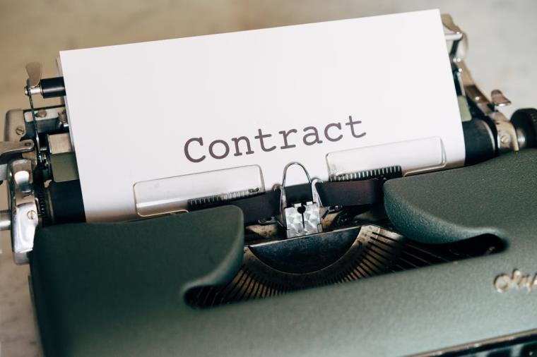 An image of a contract on a typewriter