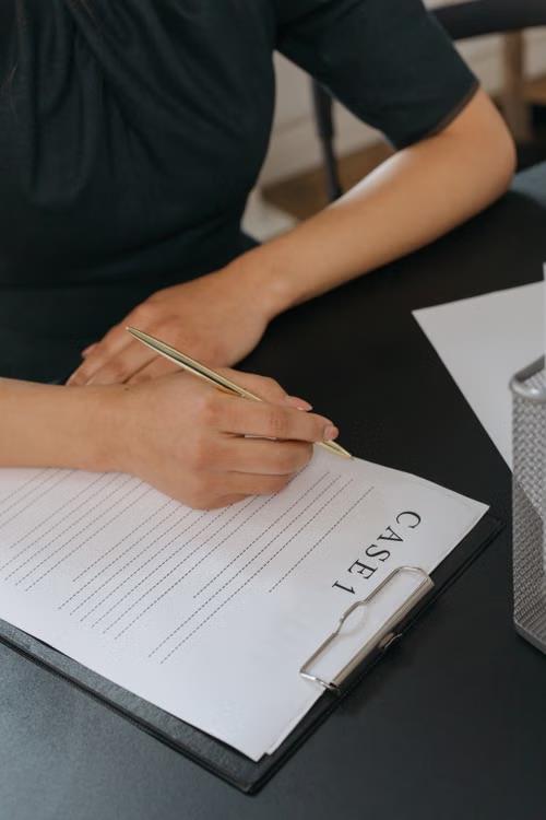 An image of a person holding a pen