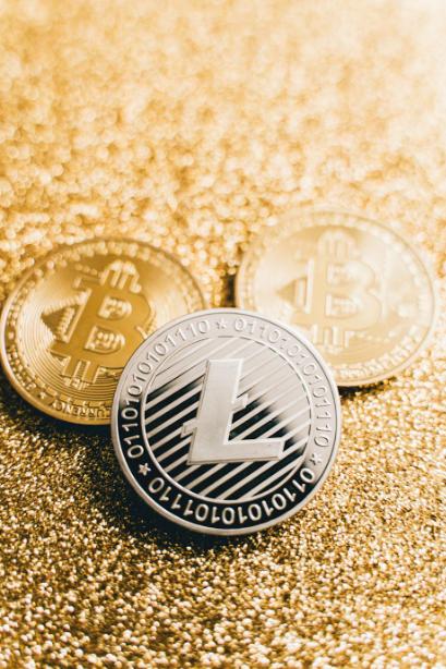 Cryptocurrency coins on a golden glitter surface