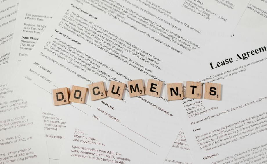 Scrabble tiles spelling documents on top of legal papers